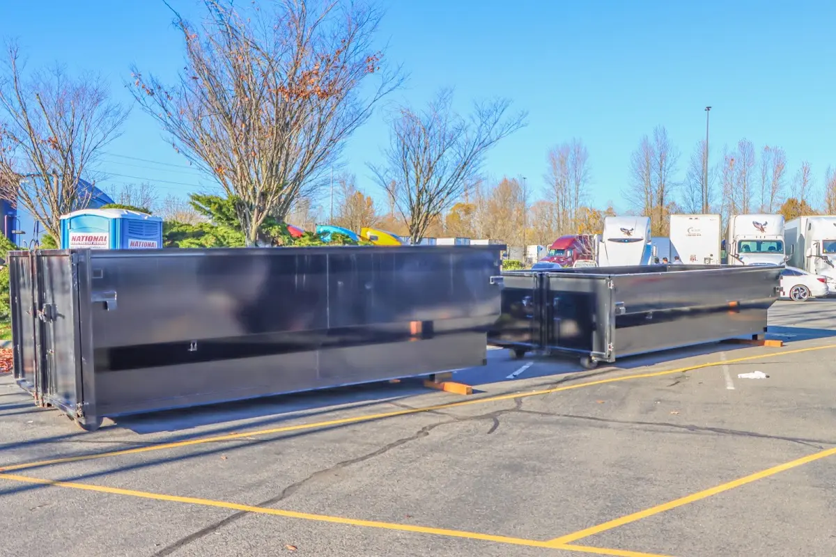 Professional dumpster rental service with roll-off container on residential driveway in Sandy